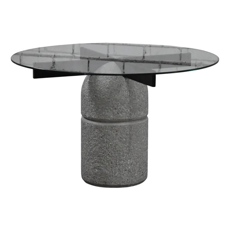 Round glass table with gray stone base