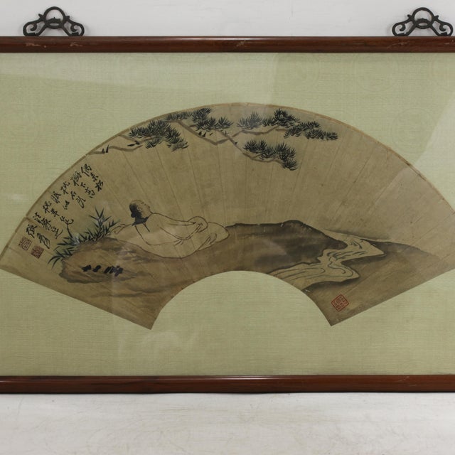 This exquisite vintage Chinese fan painting features a contemplative "Sleeping Under Pines" composition rendered in ink...