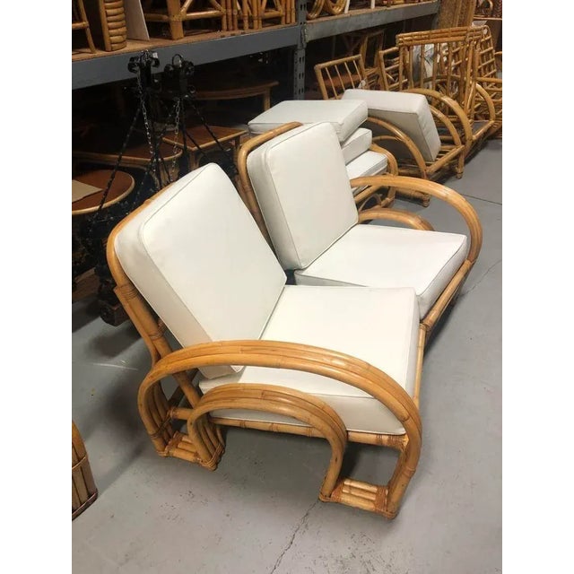 This restored mid-century rattan Double Horseshoe arm settee showcases timeless charm with its vintage appeal. Crafted...
