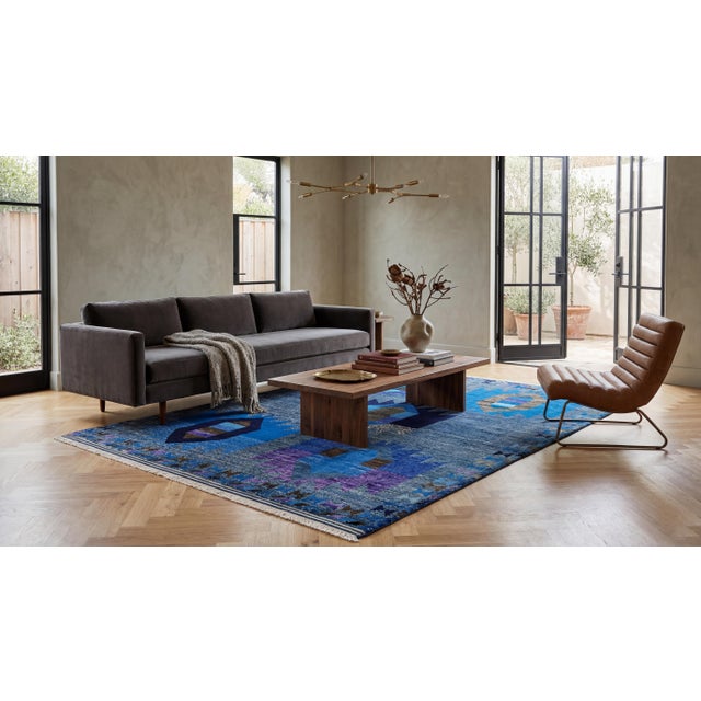 This striking modern area rug seamlessly blends traditional Baluch tribal influences with a sleek, contemporary aesthetic....