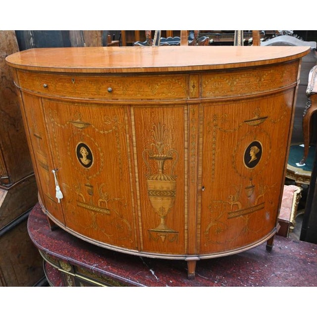 You are viewing an elegant Regency revival satinwood cabinet of demi lune form In the Adams manner features some amazing...