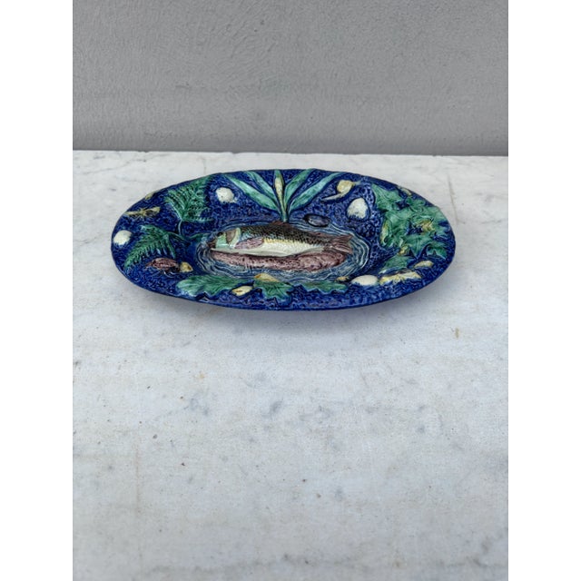 19th Century small oval Palissy Thomas Sergent. 7.5 inches W. by 4.5 inches H. Fish on the center , shells , ivy , oak...