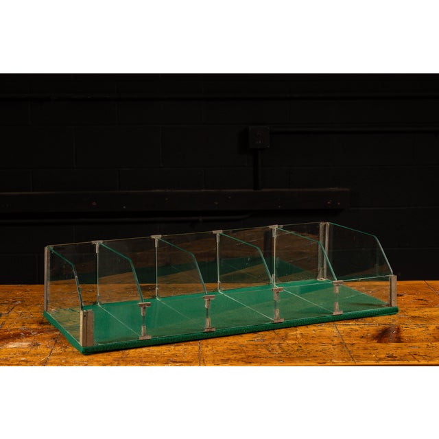 Early 20th-century point-of-sale countertop display case constructed from clear tempered glass with metal clips and...