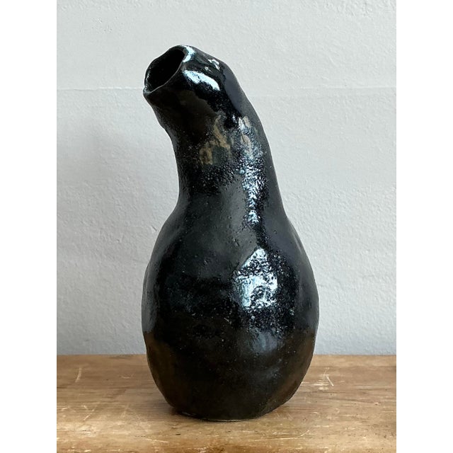 This captivating contemporary studio pottery vase is a sophisticated study in asymmetrical form and fluid design. Hand-...