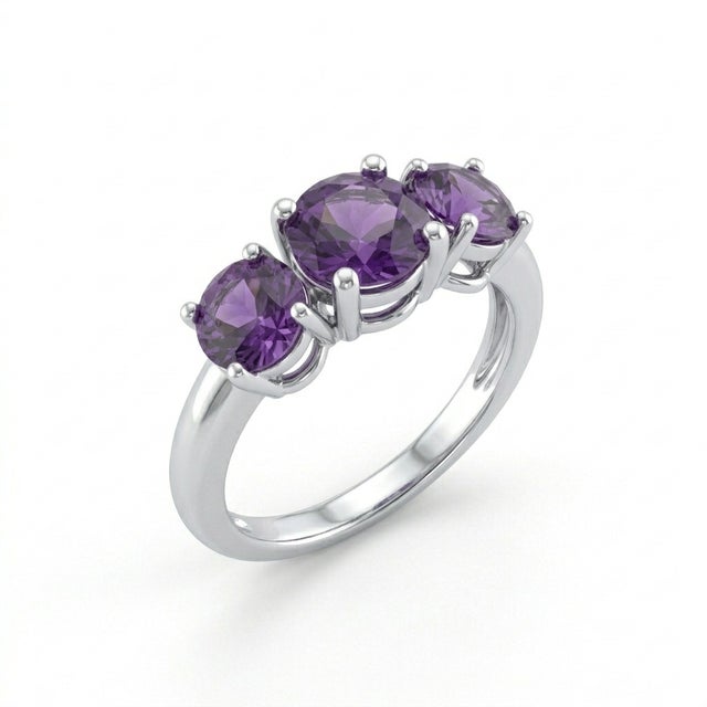 This elegant ring features three round-cut amethyst gemstones, each showcasing a stunning deep purple hue that embodies...