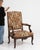A classic Louis XV armchair featuring elegant cabriole legs and curved lines, softened by detailed needlepoint upholstery....