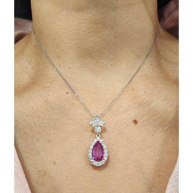 A stunning platinum pendant necklace showcasing modern elegance. This exquisite piece features a 1.97-carat natural pear-...
