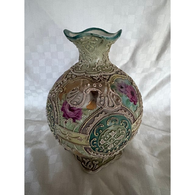A late 19th C Japanese double handles Moriage porcelain vase featuring hand painted pink and purple rose medallions...
