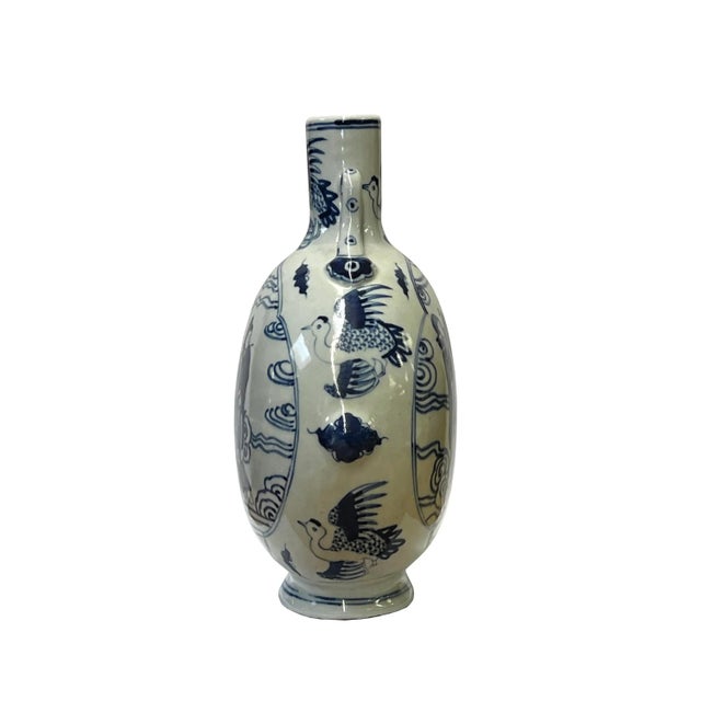 This is a Chinese decorative porcelain vase in a Blue and White color finish. The theme is an oriental people 8 Immortal...