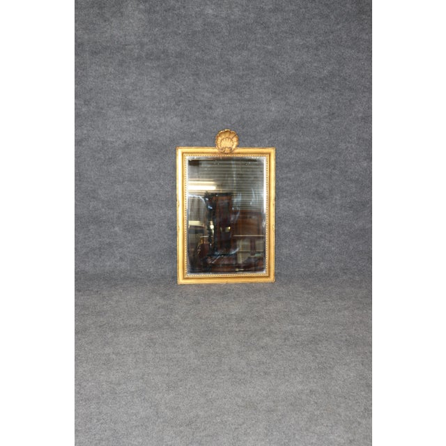 This is a gorgeous and simple Dorothy Draper era Hollywood Regency era giltwood mirror by Decorative Arts/Friedman...