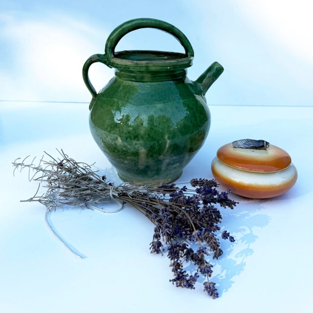 Authentic 19th century French gargoulette from Provence with a rich solid green glaze over terracotta. Once used for...