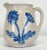 Antique McCoy Dandy line salt-glazed stoneware pitcher featuring embossed, hand-painted blue flower motif to both sides...