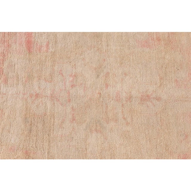 This vintage Turkish Oushak rug embodies the quiet elegance and storied craftsmanship of Anatolian textile traditions....