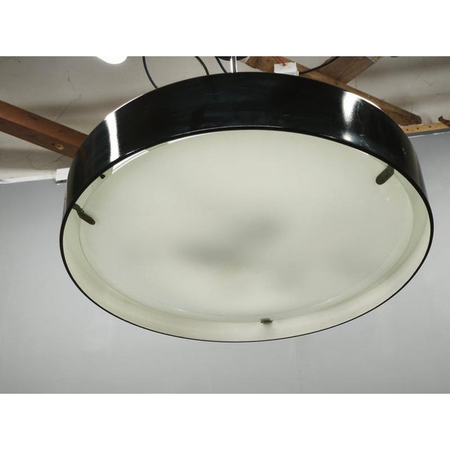 Distinctive mid-century modern pendant light by napako, type 1330, produced in czechoslovakia during the 1960s. The...