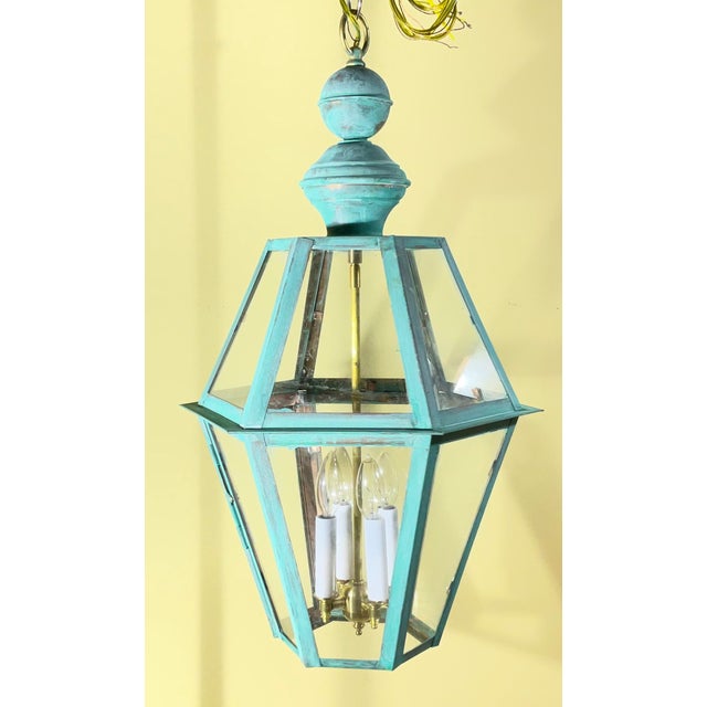 Elevate your foyer, porch, or dining space with this striking vintage solid copper hanging lantern, featuring a classic...