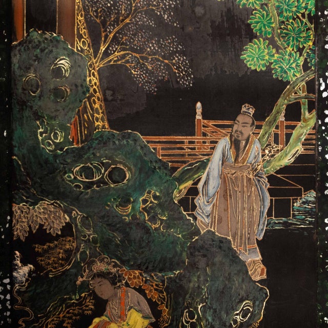 It is made of stuccoed and black lacquered wood. A scene from a traditional Chinese garden is depicted on the lacquer. It...