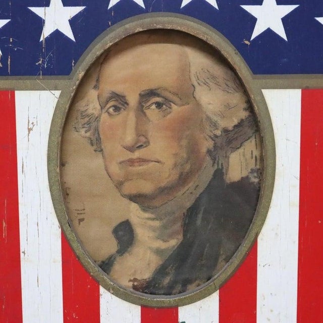 This vintage Americana wooden shield, dating to approximately C1950, features a patriotic design with red and white...