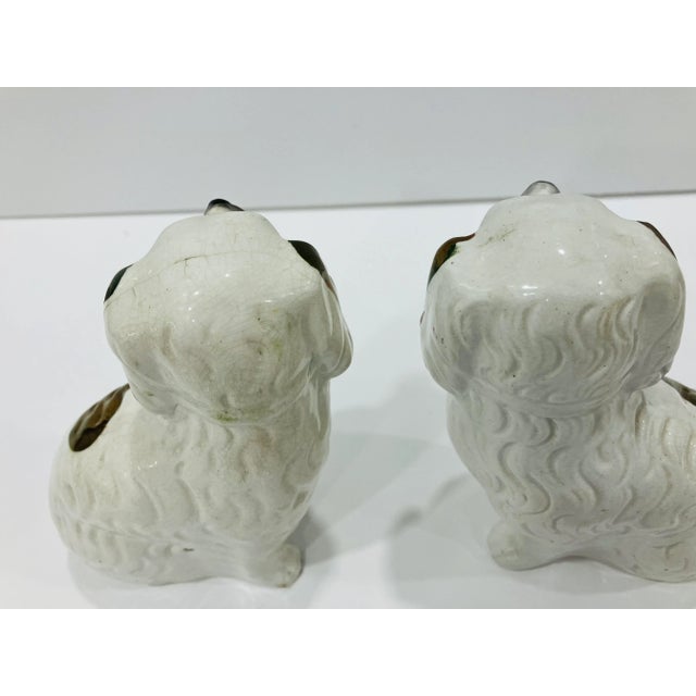 This pair of Staffordshire dogs have copper luster decoration. There are defined paws, collars & padlocks These date from...