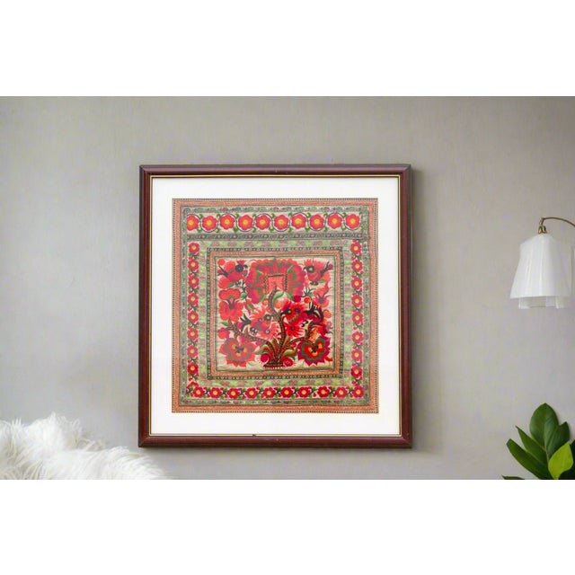 An antique Chinese embroidered textile, a vibrant celebration of flora and fauna. This captivating piece, possibly...