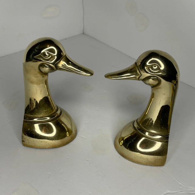 A pair of duck head brass bookends with a felted bottom. Both bookends have been polished, but could likely use some...