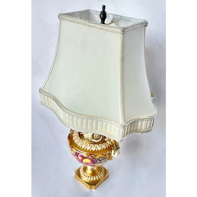 Antique Royal Worcester bone china fruit and caryatid urn vase style lamp with caryatid handles. Abstract acanthus leaf...