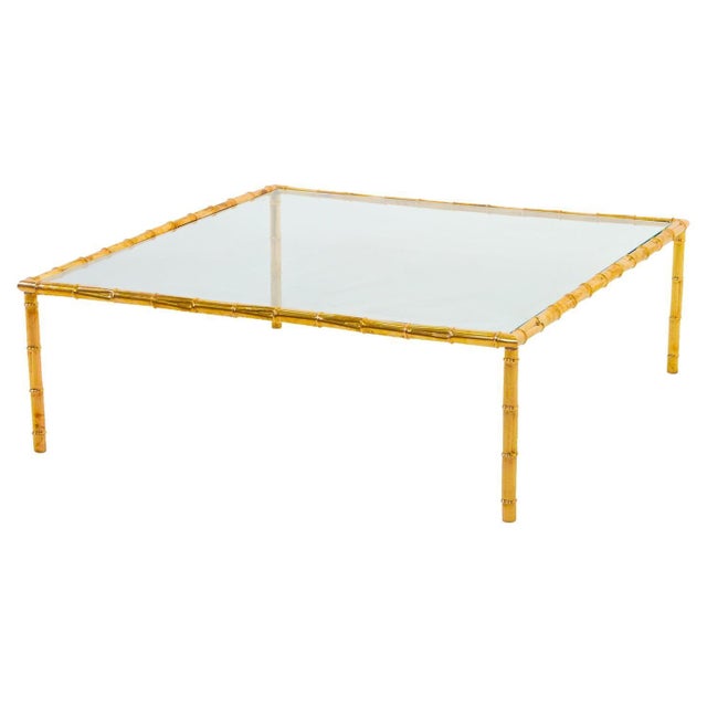 Large modernist brass coffee table. Stylized bamboo motif. Glass and brass.