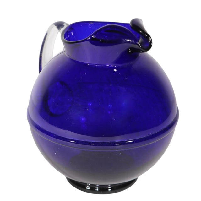 Chic Art Deco cobalt glass ball form pitcher with clear glass applied handle. Made in the USA by the Cambridge Glass...