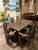 This dining set, crafted from solid oak, consists of 8 chairs and a matching table, exuding a distinctive rustic charm. A...