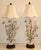 A pair of Mid-Century Italian tole table lamps. Featuring white lily flowers with light green leaves and a dark wood base....