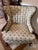 This lovely Vintage Mid-Century set has two wingback chairs with an ottoman. The upholstery has an Ivory floral brocade...