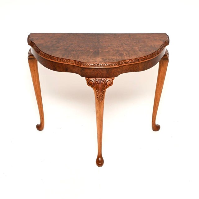 A gorgeous antique burr walnut console table in the Queen Anne style. This was made in England, it dates from around the...