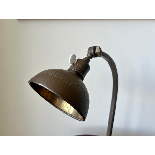 Original early 20th century art deco period table/desk lamp in brass from France. A very elegant, well proportioned...