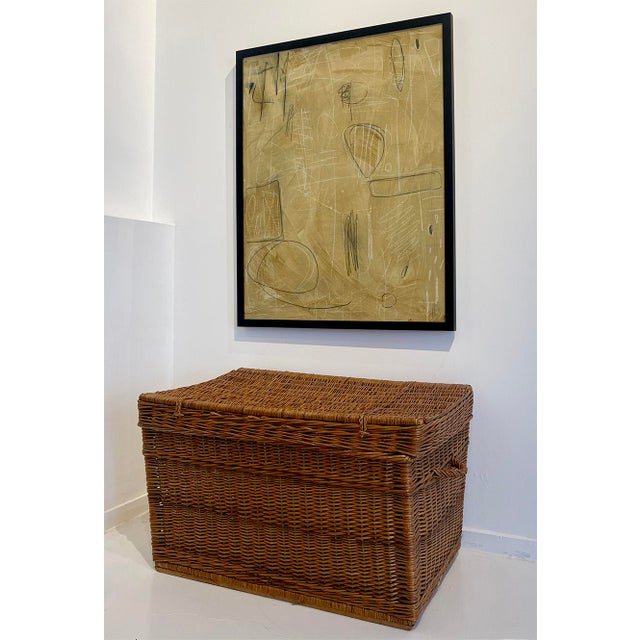 This mid-20th century vintage wicker storage trunk features a clean, rectilinear form with finely executed hand-woven...