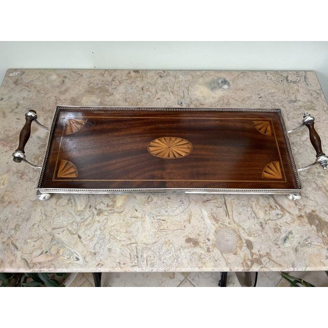 Mahogany and inlaid fruitwood galleried butlers tray with silver plated bun feet and swan neck handles
