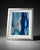 Modern abstract artwork featuring layered organic shapes in shades of blue, navy, turquoise, gray, and metallic silver....