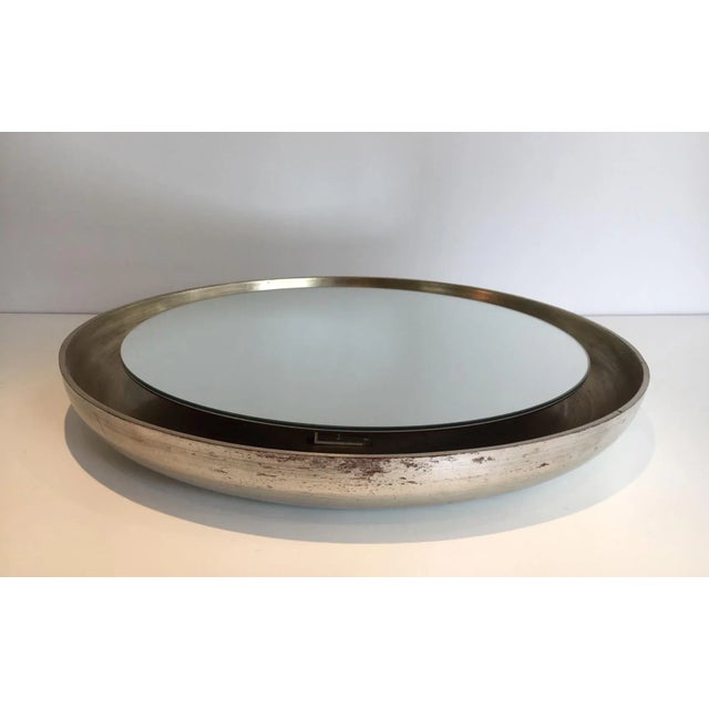 This mirror is made of curved wood in a reddish and silver color. This is an unusual model which shape is very nice, circa...