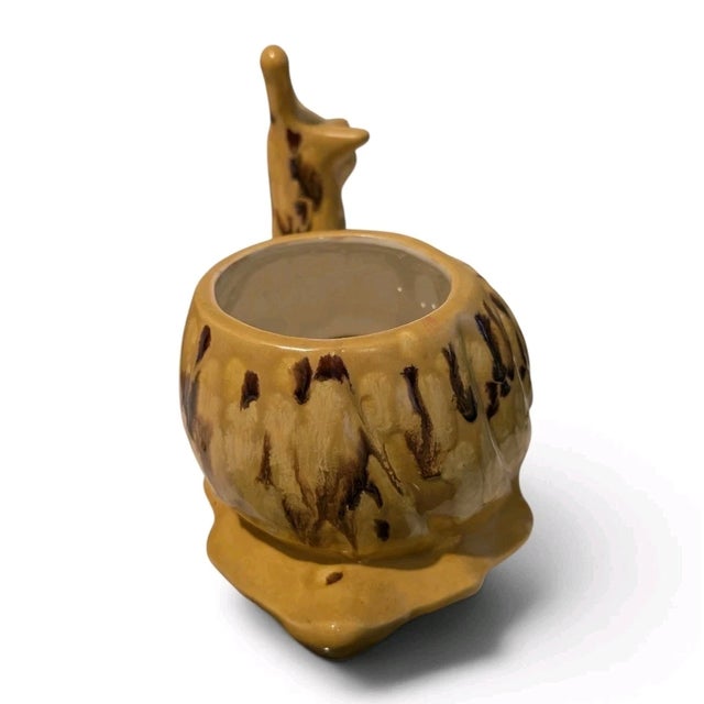 Add a whimsical touch to your vintage décor with this **Vintage 1979 Ceramic Snail Planter**. This charming figural...
