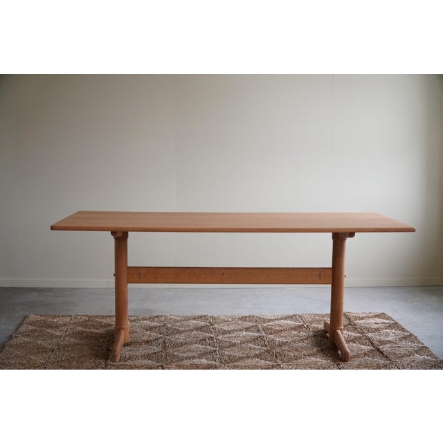 An elegant and classic rectangular dining table in a solid oak frame & teak veneered top. Designed by the danish couple...