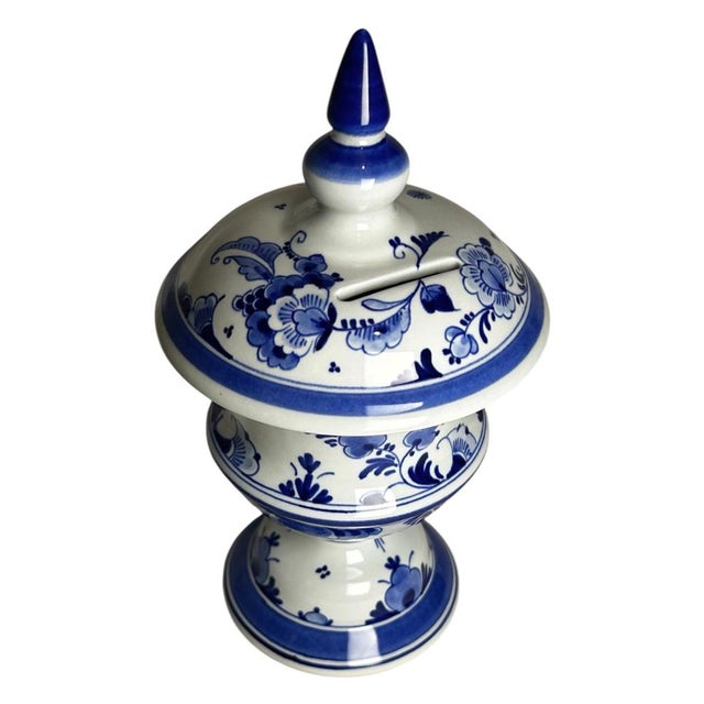A vintage hand-painted royal delft money box by de porceleyne fles, dated 1989 by the year code di. The piece has an urn-...