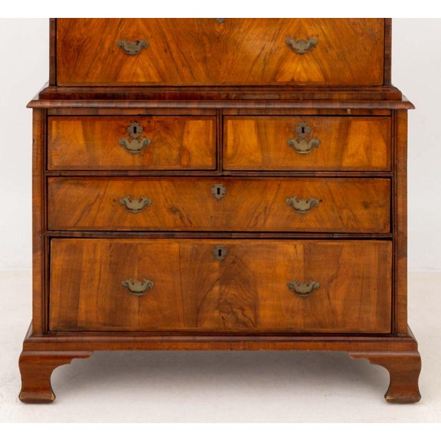 George II Walnut and Feather-Banded Chest on Chest, the top have with two short drawers above three graduated frieze...