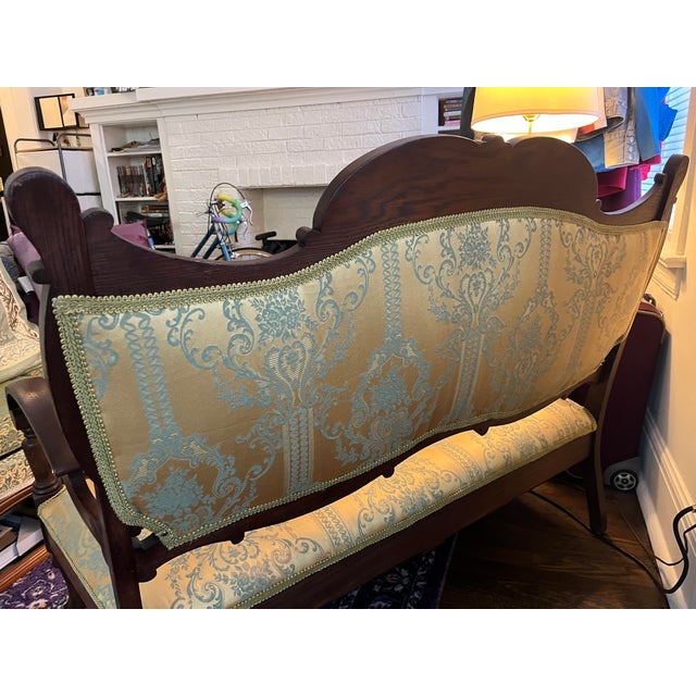 Gorgeous settee in excellent condition. Gold fabric with aqua highlights and a dark wood frame. Settee was refurbished in...