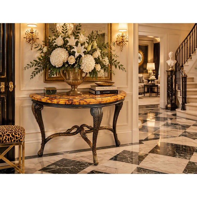 Offering an exquisite demi-lune console table featuring a stunning geometric lacquered pen shell veneer top in rich amber...
