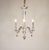 This small and gorgeous Dresden porcelain chandelier has three undulating arms with hanging floral bouquet baubles....