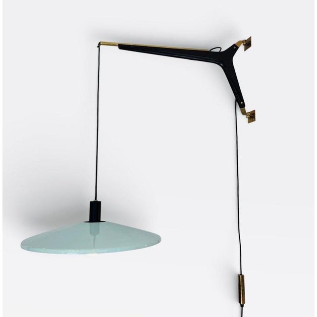 This rare and large adjustable wall lamp, designed and crafted by Stilnovo in the 1950s, stands out as a unique piece due...