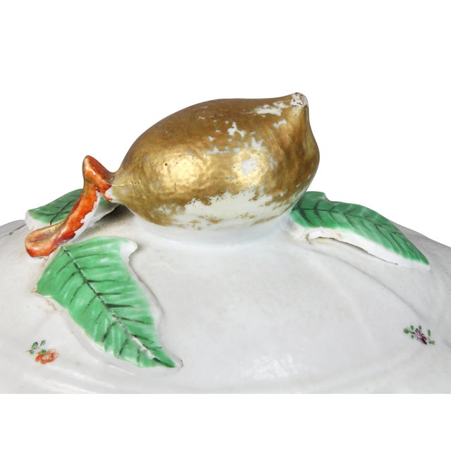 With domed cover with gilt lemon finial on a conforming base with two handles.