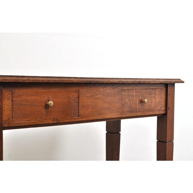 Beautiful and stylish oak side table with two drawers. The side table dates from around 1900, is handcrafted, and has a...