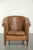 This lovely, large, and comfortable vintage sheepskin club armchair is crafted in a light cognac color and finished with...