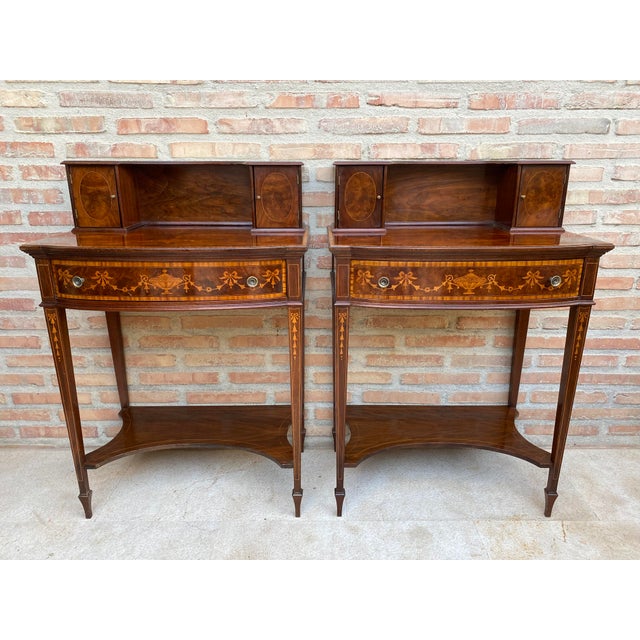 Elegant pair of Neoclassical-style bedside tables, finely crafted in wood and decorated with detailed marquetry and...