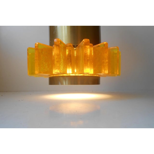 This Danish pendant lamp was designed in a Space Age style. It consists of yellow acrylic panels set in a star formation...