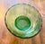 This elegant mid-century emerald green bowl featuring a scalloped rim and ribbed pedestal base was manufactured by E.O....